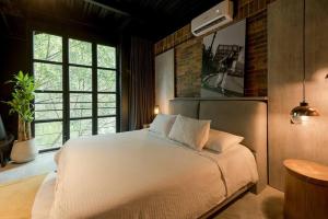 Postel nebo postele na pokoji v ubytování Hotel Meridiano Lofts