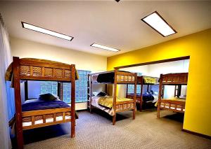 a room with three bunk beds and two mirrors at the weekend hostel in La Paz