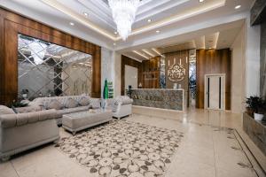 a large living room with couches and a chandelier at Art Regency Premium Hotel, Free Airport Shuttle Service in Tashkent