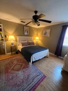 a bedroom with a bed and a ceiling fan at Southern’s Beauty2 very close to airport in Kenner