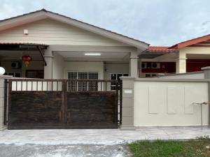 a house with a wooden gate and a fence at DE WHITE HOMESTAY . PORT DICKSON in Port Dickson