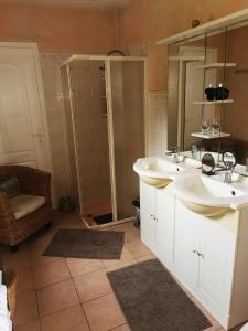 a bathroom with two sinks and a shower at jeanguy andrieu in Labruguière