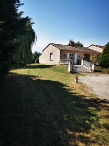 a house with a tree in front of a yard at jeanguy andrieu in Labruguière