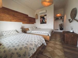 a bedroom with two beds and a dresser at Pavi home in Sa Pa