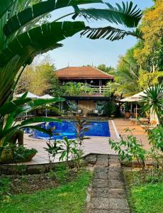 a resort with a swimming pool and a building at TARA LODGE Haven of peace in Kep