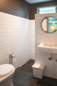 a bathroom with a toilet and a sink at Villa Jenis By The Villas 100 in Bogor