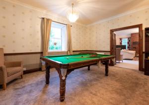a living room with a pool table in it at Aberhiriaeth Hall in Cemmaes