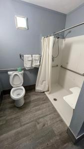 a bathroom with a toilet and a bath tub at Jackson Motel in Murfreesboro