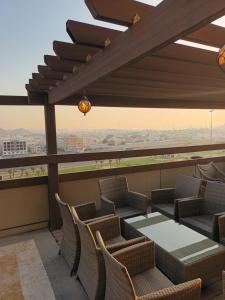 a balcony with chairs and a table and a view at فندق الشهباء جده Al Shahba Jeddah in Jeddah