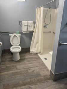 a bathroom with a toilet and a shower at Jackson Motel in Murfreesboro