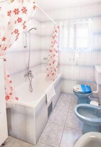 a bathroom with a tub and a toilet and a sink at Apartment Tomi - with large terrace (60m2) in Trogir