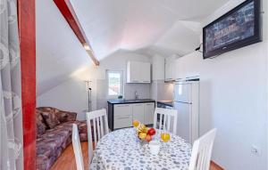 eine Küche und ein Esszimmer mit einem Tisch und Obst darauf in der Unterkunft Apartments Niks - terrace & sea view in Vela Luka