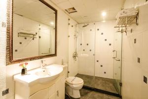 a bathroom with a sink and a toilet and a shower at Wild Lotus Hotel & Travel 2 in Hanoi