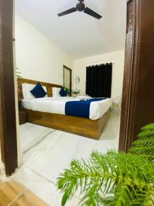 a bedroom with a large bed with a ceiling fan at Hotel KP Suites Airport in Shamshabad