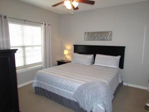 a bedroom with a bed and a ceiling fan at Walk-in level Condo B-6 Near Lake in Hollister