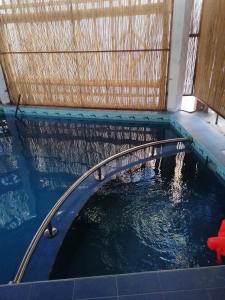 a pool of water in a room with a fence at Hai alturath in Nizwa