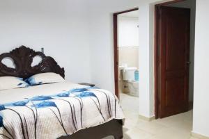 a bedroom with a bed with a wooden head board at Sientete como en casa. in El Seis
