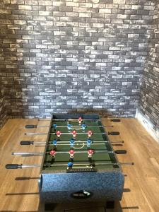 a ping pong table in front of a brick wall at 麗base野芥 in Fukuoka