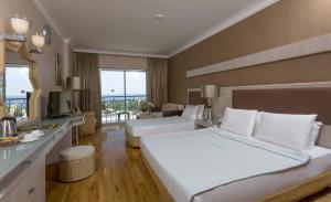 A bed or beds in a room at Mukarnas Spa & Resort Hotel