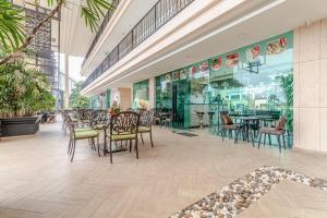 a restaurant with tables and chairs in a building at City Garden Tower 1 bedroom in Pattaya South