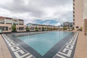 a large swimming pool in the middle of a building at City Garden Tower 1 bedroom in Pattaya South