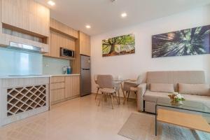a living room with a couch and a table at City Garden Tower 1 bedroom in Pattaya South