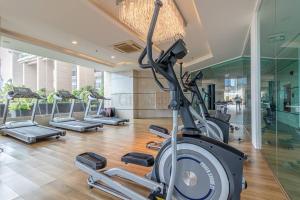 a gym with a row of exercise bikes in a building at City Garden Tower 1 bedroom in Pattaya South