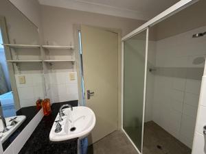 a bathroom with a sink and a shower at Elegant 2 Bedroom home close to city buz Bridge RD 2 E-Bikes Included in Sydney