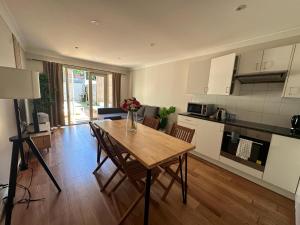 a kitchen with a table and chairs in a room at Elegant 2 Bedroom home close to city buz Bridge RD 2 E-Bikes Included in Sydney