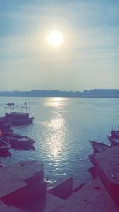 a group of boats sitting in the water at Tandon Lodge in Varanasi
