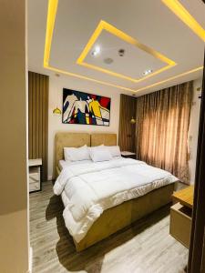 a bedroom with a large bed in a room at Casa in Abuja