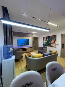 a living room with a couch and a tv at Casa in Abuja