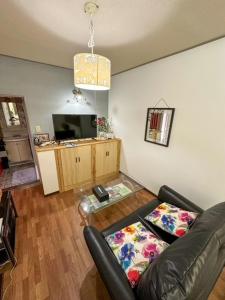 a living room with a couch and a television at Hotel Rakusai in Kyoto