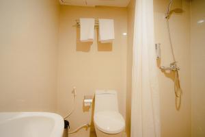 a bathroom with a toilet and a sink and a shower at Portola Arabia Hotel Banda Aceh in Banda Aceh
