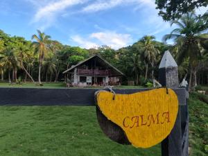 a sign that reads cslma in front of a house at El Hongo Finca Hostal / Camping in Capurganá