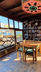 a room with a table and chairs and a book shelf at Mirage Village in Dahab