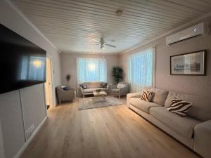 a living room with a couch and a table at Spacious apartment in the city center in Vaasa