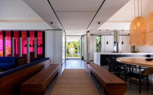 a dining room and kitchen with benches and a table at Luxury Vacation Villa 20 in Pointe Milou