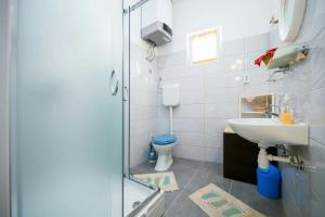 a bathroom with a sink and a toilet at Seafront apartment Jurkovica in Komiža