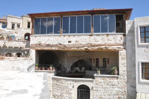 a large stone building with a large window at Antique House Cappadocia in Nevsehir