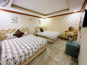 Postel nebo postele na pokoji v ubytování Xing City Hotel Dalat