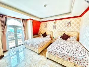 Postel nebo postele na pokoji v ubytování Xing City Hotel Dalat