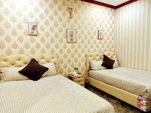 Postel nebo postele na pokoji v ubytování Xing City Hotel Dalat