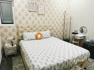 Postel nebo postele na pokoji v ubytování Xing City Hotel Dalat