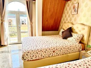 Postel nebo postele na pokoji v ubytování Xing City Hotel Dalat