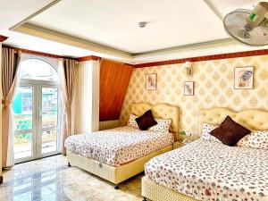Postel nebo postele na pokoji v ubytování Xing City Hotel Dalat
