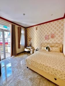 Postel nebo postele na pokoji v ubytování Xing City Hotel Dalat