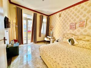 Postel nebo postele na pokoji v ubytování Xing City Hotel Dalat