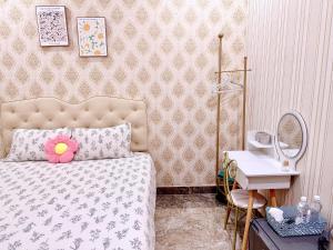Postel nebo postele na pokoji v ubytování Xing City Hotel Dalat