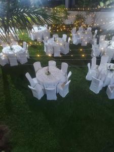 a group of white tables and chairs with lights at Kiriri Residence Hotel in Bujumbura +33 photos